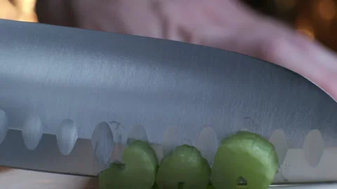 Cutting celery using kitchen knife on wooden board, Fresh healthy celery for Stock-Footage 148241322
