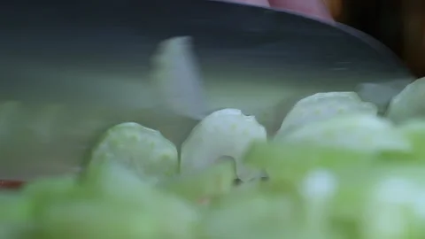 Cutting celery using kitchen knife on wooden board, Fresh healthy celery for 스톡 동영상 155438136