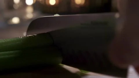 Cutting celery using kitchen knife on wooden board, Fresh healthy celery for Stock Footage 165773195