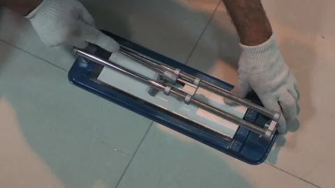 Cutting ceramic tile  . Person placing a big ceramic tile in a cutter Stock Footage 89541845