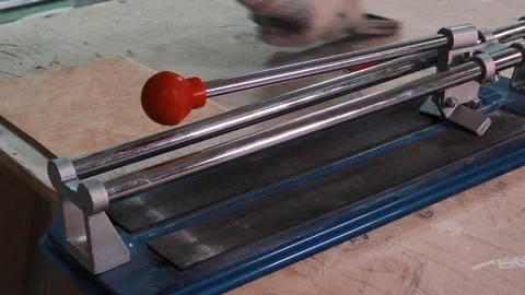 Cutting ceramic tile  . Person placing a big ceramic tile in a cutter Stock Footage 89541933