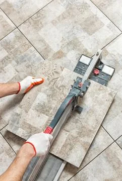 Cutting a ceramic tile. Stock Photos