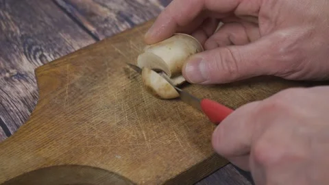 Cutting champignon on a cutting board Stock Footage 142780409