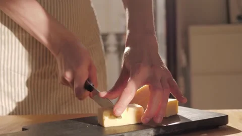 Cutting cheddar on board close-up. Hard cheese, fresh parmesan. Stock Footage 172265309