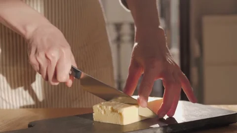 Cutting cheddar on board close-up. Hard cheese, fresh parmesan. Stock Footage 172556633