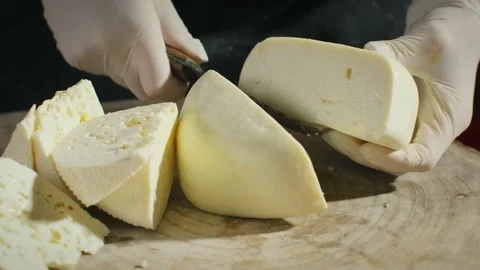 Cutting cheese head in half Stock Footage 138192792