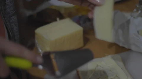 Cutting cheese on the kitchen table Stock Footage 105242885