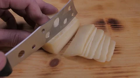 Cutting cheese with knife slow motion 4k Video stock 150604280