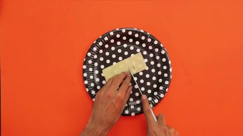 Cutting cheese on orange background 002 Stock Footage 242959072