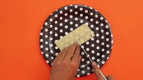 Cutting cheese on orange background 003 Stock Footage 242959167