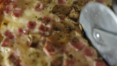 Cutting cheese pizza macro closeup cheese ham mushrooms round cutter knife Stock Footage 138097817