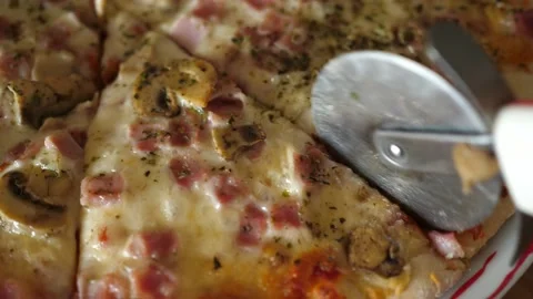Cutting cheese pizza macro closeup cheese ham mushrooms round cutter knife Stock-Footage 138577653