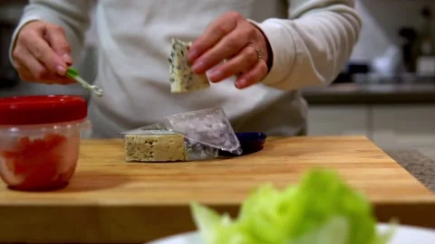 Cutting cheese for salad Stock Footage 169544949