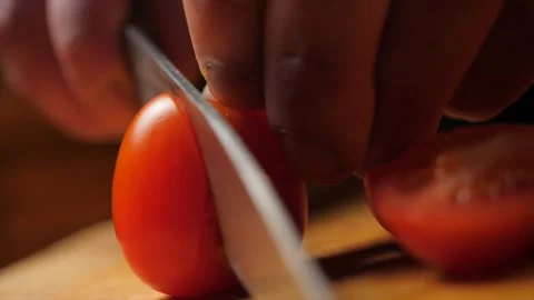 Cutting cherry tomatoes with a knife. Video stock 142423027