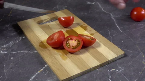 Cutting cherry Tomatoes on a table Stock Footage 242361931