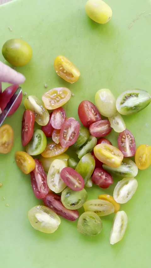 Cutting cherry tomatoes vertical Stock Footage 219286040
