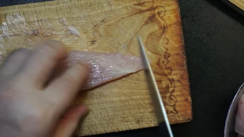 Cutting chicken breast overhead Stock Footage 98360759