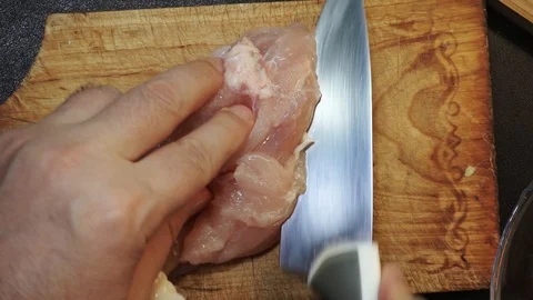 Cutting chicken overhead Stock Footage 98360748