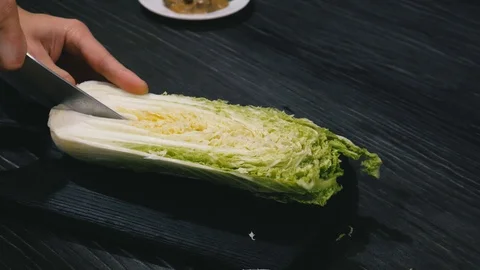 Cutting Chinese cabbage into pieces Stock Footage 101112763