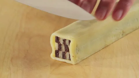 Cutting chocolate and vanilla biscuit dough into thin slices Stock Footage 24662978