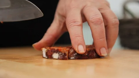 Cutting chorizo in equal Stock Footage 88813594