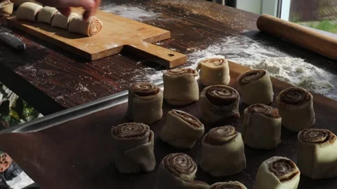 Cutting Cinnamon Roll Log into Individual Swirls for Homemade Cinnabon Pastries, Stock Footage 310337566
