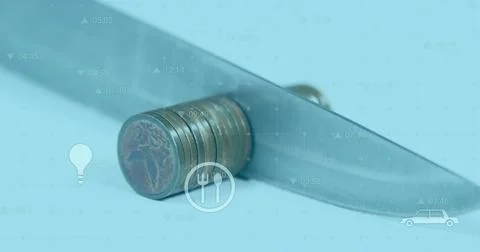 Cutting coin stack under knife blade on blue studio surface, with grid overlay Stock Photos