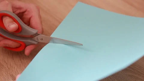 Cutting colorful blank paper sheet with scissors Видео 86232022