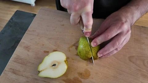 Cutting Comice pear into quarters Vidéo 347011916