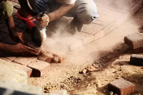 Cutting Concrete Pavement Blocks with Angle Power Disc Grinder Stock Photos