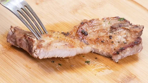 Cutting a Cooked Pork Chop 3 Video stock 136206582