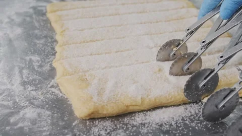 Cutting Cookie Dough With Pastry Wheels. Bakery production Stock Footage 321544856