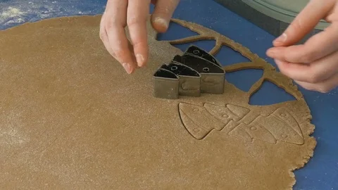 Cutting cookies in shape of christmas tree, extreme closeup color graded Stock Footage 83434652