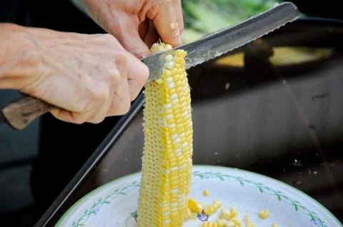 Cutting corn of the cob Stock Photos