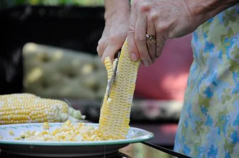 Cutting corn of the cob Stock Photos