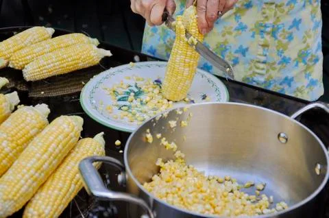 Cutting corn of the cob Stock Photos