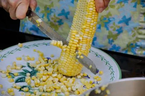 Cutting corn of the cob Stock Photos