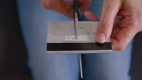 Cutting off a credit card with scissors Video stock 158995809