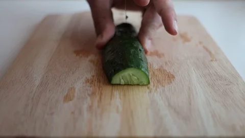 Cutting the cucumber on the kitchen board Stock Footage 127703633