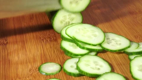 Cutting Cucumber with Knife in small Slices Stock Footage 276642833