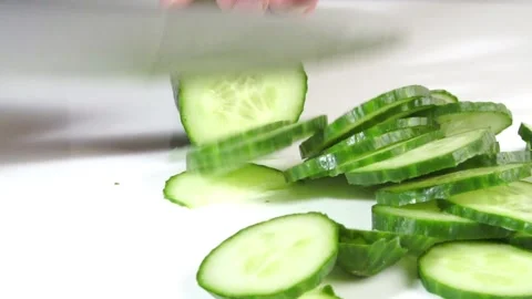 Cutting Cucumber with Knife in small Slices 50FPS Stock Footage 276748069