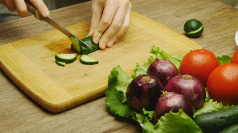 Cutting cucumber wooden table Stock Footage 67999650