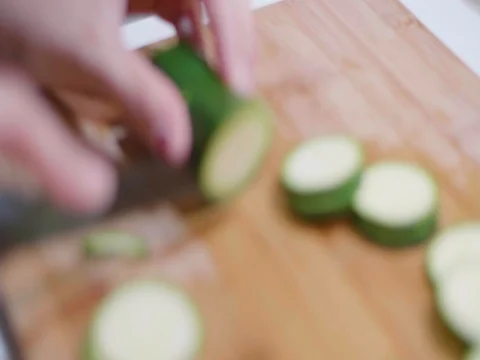 Cutting cucumbers in slow motion Stock Footage 80545018
