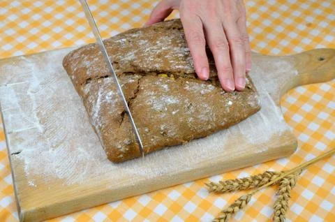 Cutting Dark Bread Stock Photos