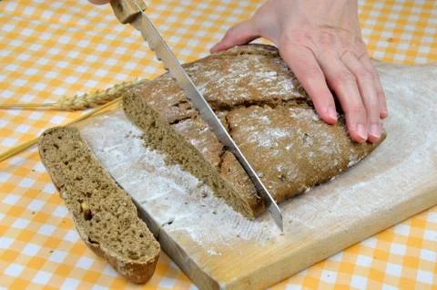 Cutting Dark Bread Stock Photos