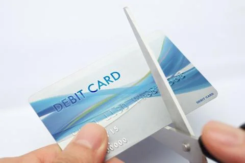 Cutting debit card Stock Photos