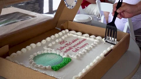 Cutting a Decorated Celebration Sheet Cake Inside a Cardboard Box Stock Footage 337637718