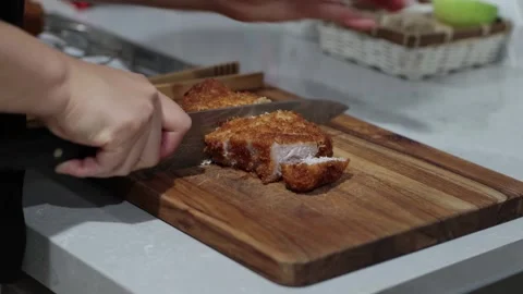 Cutting deep fried pork chop, evening kitchen, 4k Stock Footage 252167713