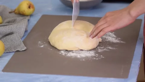 Cutting dough to shape it for bread baking. 動画素材 162773143