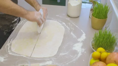 Cutting the dough using a plate Stock Footage 145648530